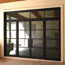 Large iron French front door with sidelights and transom