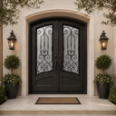 Arched iron double front door with balanced scrollwork