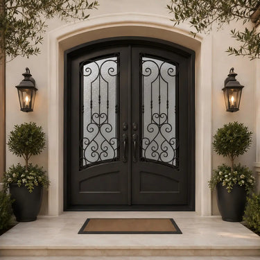 Arched iron double front door with balanced scrollwork