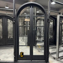 Iron French front door with round top and kickplate