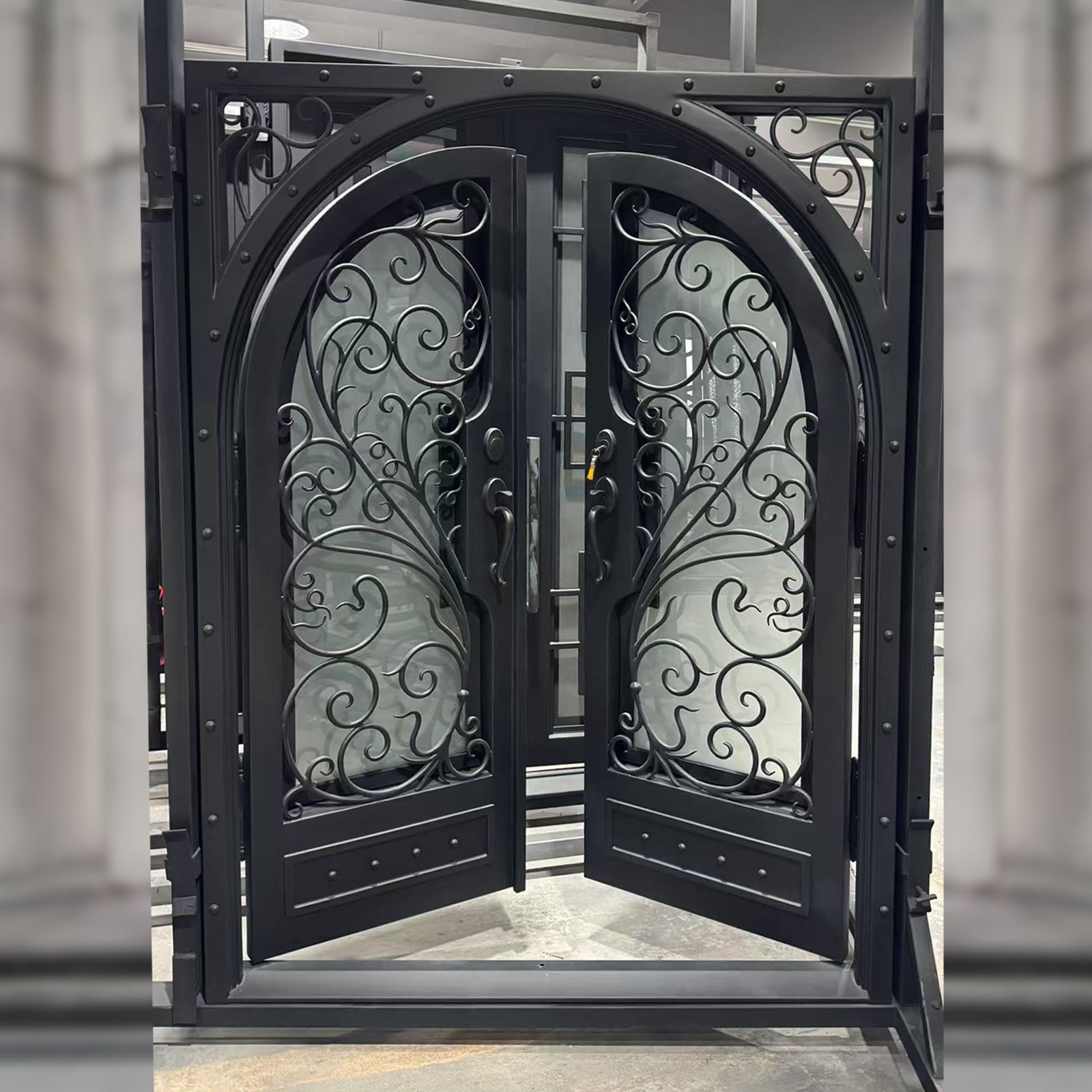 Decorative wrought iron gate with intricate designs in an indoor setting