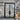 Double iron front door with glass sidelights and transom