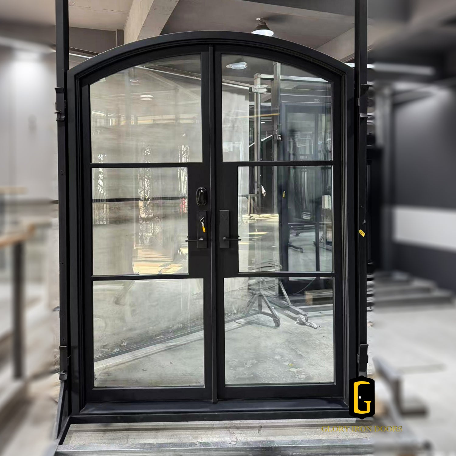 Eyebrow arched iron French door with 4 lite glass