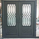 Decorative iron front door with operable glass panels