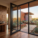 Thermal break pivot door with clear glass opening to a landscaped backyard