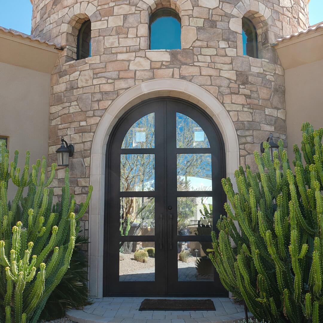 iron french double door with round top and hurricane proof glass