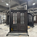 Custom iron double entry door with divided glass panels