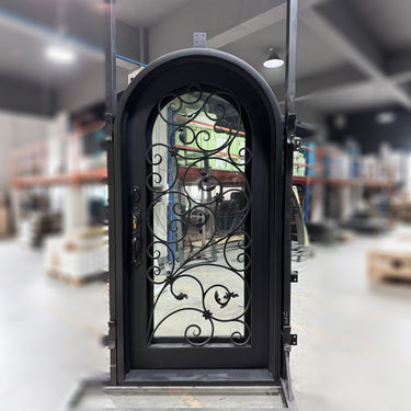 Decorative wrought iron door with scrollwork and round top