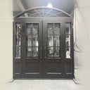 Black iron entry door with sidelights and lower kickplate
