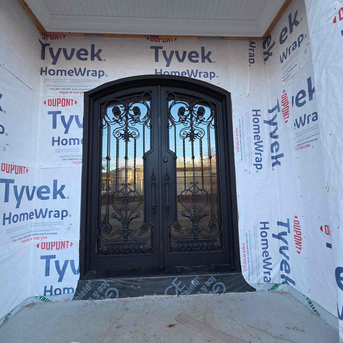 Iron Front door of a house with Tyvek HomeWrap covering the walls.
