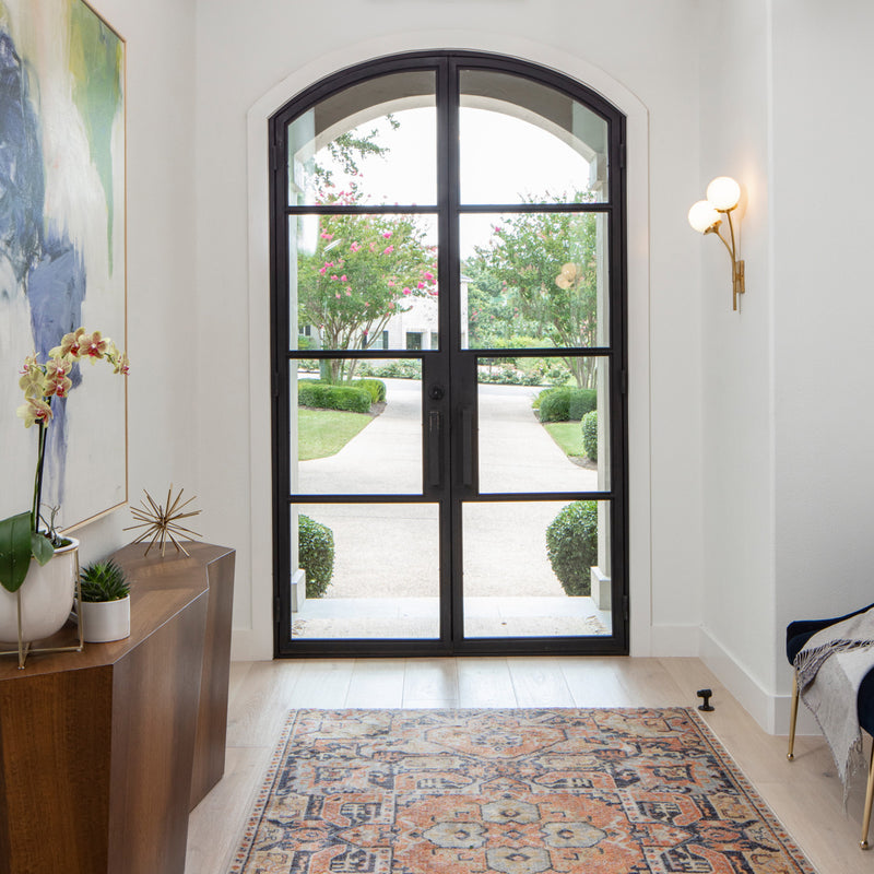 Arched iron French double door with clear glass