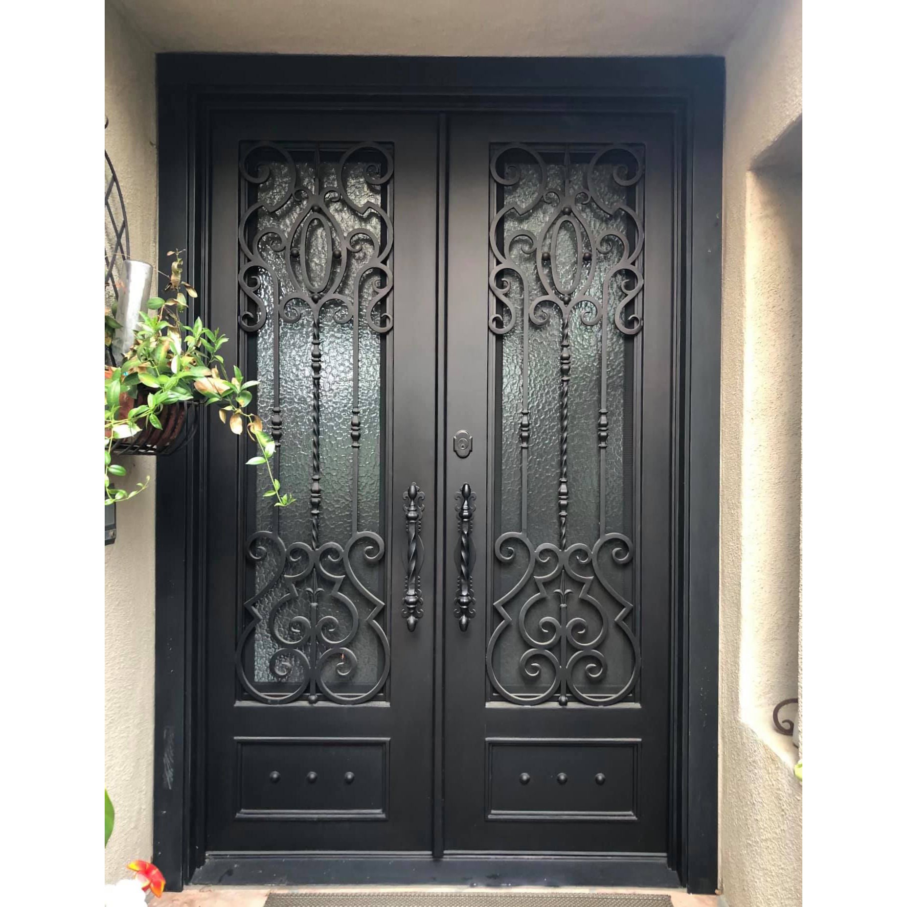 wrought iron double entrance door with water cubic glass