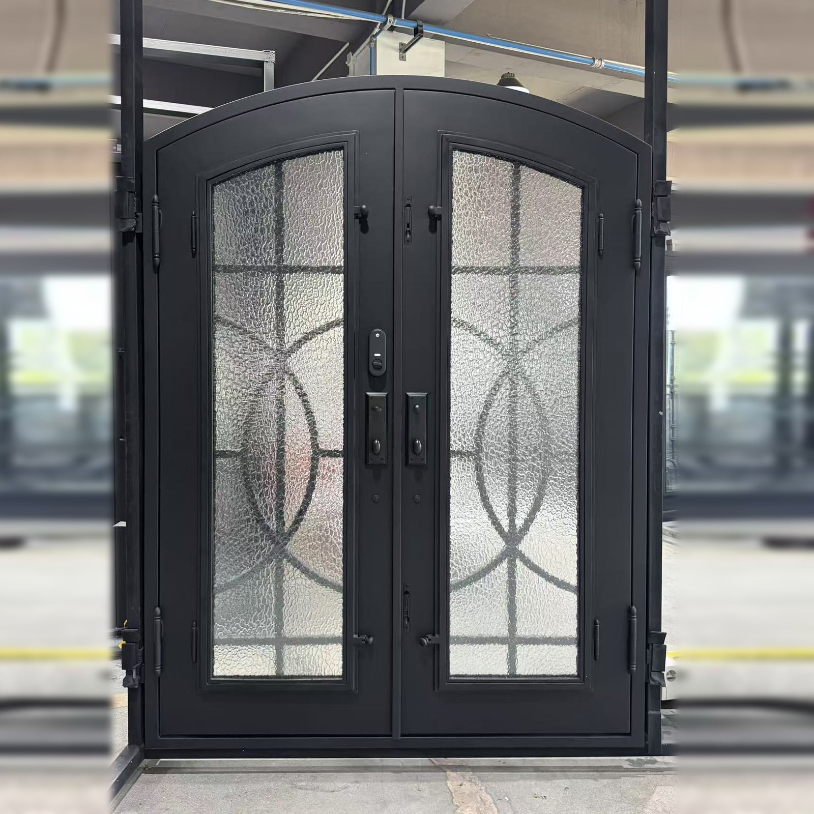 gid arched top wrought iron double door with black finish and simple scrollwork