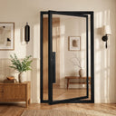 Modern black iron pivot door with full clear glass panel for interior use