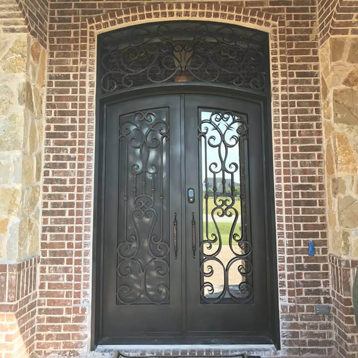 double iron door with arched top and transom