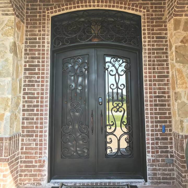 double front iron door with arched top and arched transom