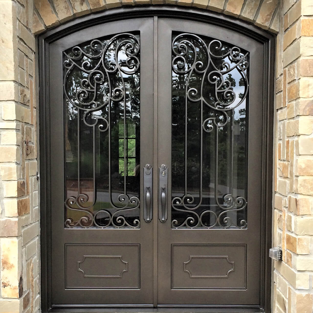 double iron door with clear glass and arched top