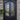 double iron door with decorative scrollwork and square top arched inside