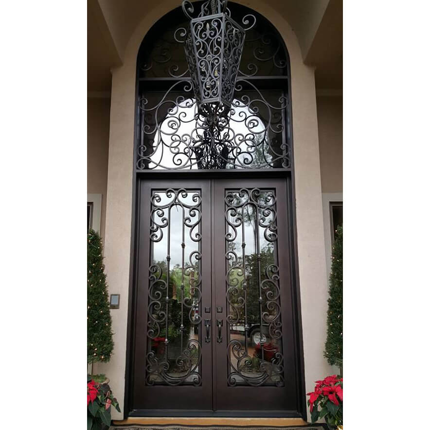 double iron door with large transom and exquisite scrollwork